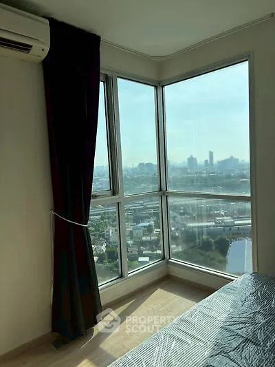 Bright bedroom with panoramic city view and large windows