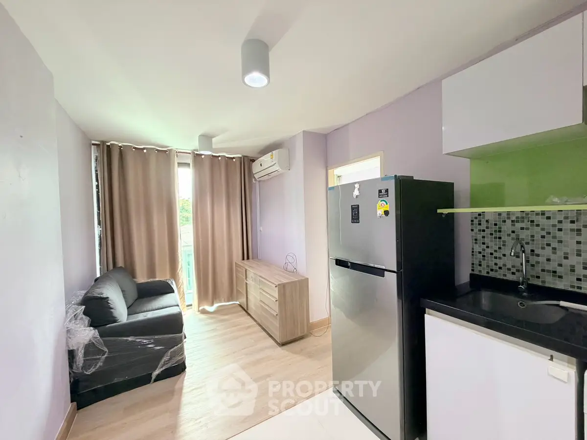 Modern living room with sleek furniture and balcony view in a stylish apartment.