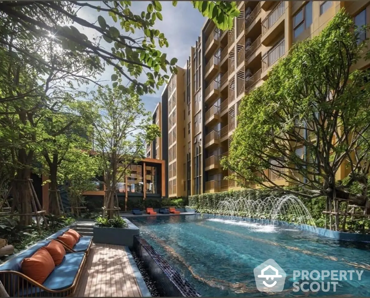 Luxurious apartment complex with stunning pool and lush greenery.