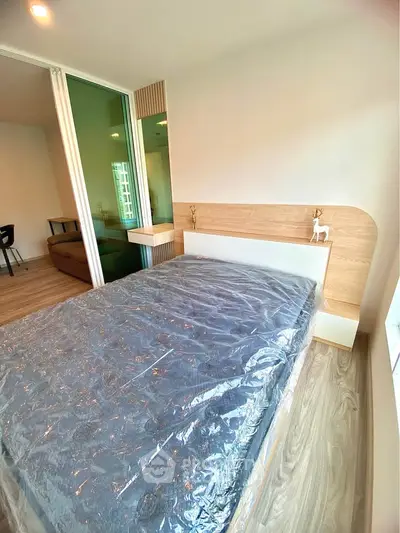 Modern bedroom with sleek design and natural light, featuring a cozy bed and stylish decor.