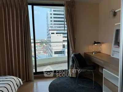 Modern bedroom with city view and sleek workspace