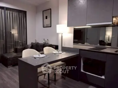 Modern open-layout kitchen and living area with sleek design and cozy ambiance.