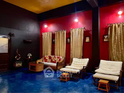 Charming living room with vibrant red walls and cozy seating area.