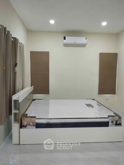 Modern bedroom with minimalist design and air conditioning unit