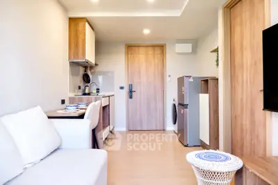 Modern compact living room with kitchen and dining area, featuring wooden accents and cozy decor.