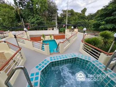 Luxurious poolside view with jacuzzi and lush greenery, perfect for relaxation and leisure.