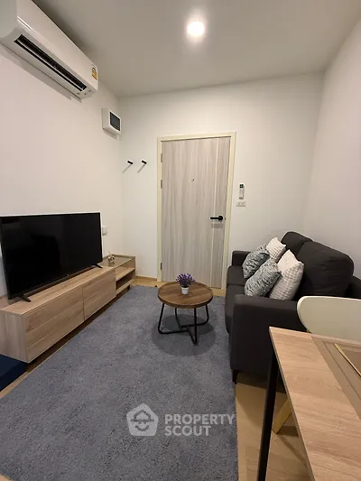 Cozy modern living room with stylish furniture and air conditioning