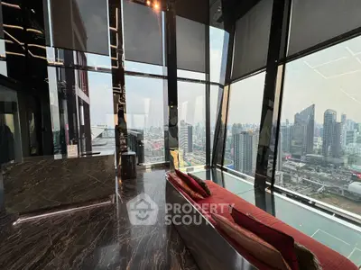 Luxurious high-rise living room with panoramic city views and modern design.