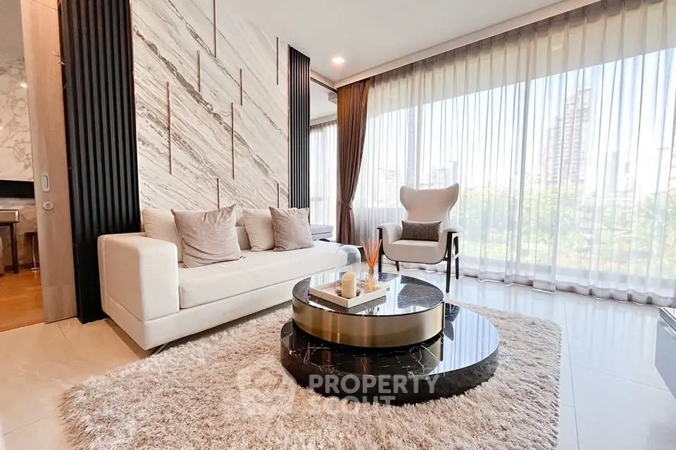 Luxurious living room with modern decor and large windows offering stunning city views.
