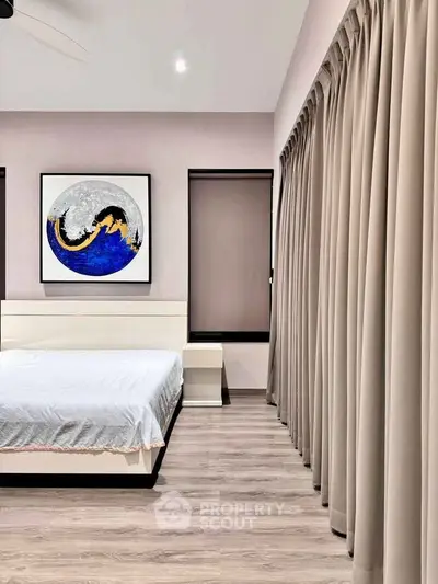 Modern bedroom with elegant decor and large window curtains