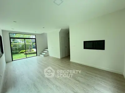 Spacious modern living room with large windows and garden view