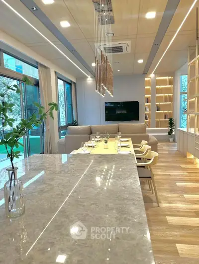 Luxurious open-plan living room with modern dining area and elegant lighting