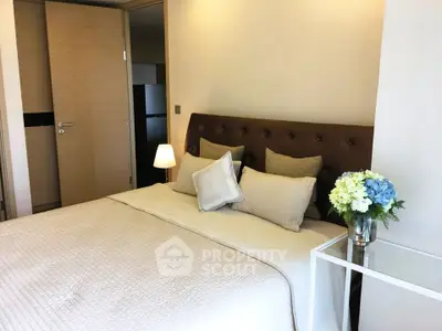 Cozy bedroom with elegant decor and soft lighting, perfect for relaxation.