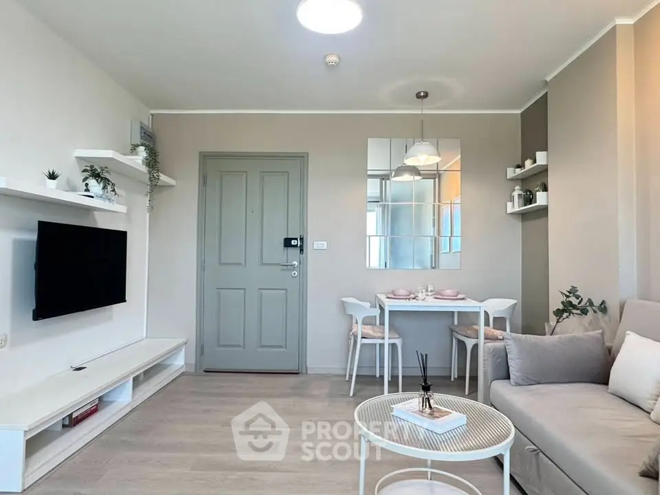 Modern living room with stylish decor and dining area, featuring neutral tones and sleek furniture.