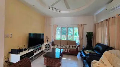 Spacious living room with modern furniture and large window view