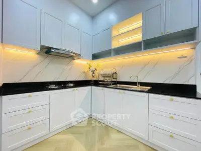Modern kitchen with sleek white cabinets and marble backsplash