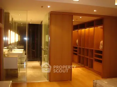 Luxurious modern bathroom with walk-in closet and elegant lighting