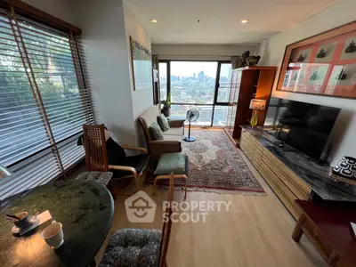 Spacious living room with city view, elegant decor, and natural light.