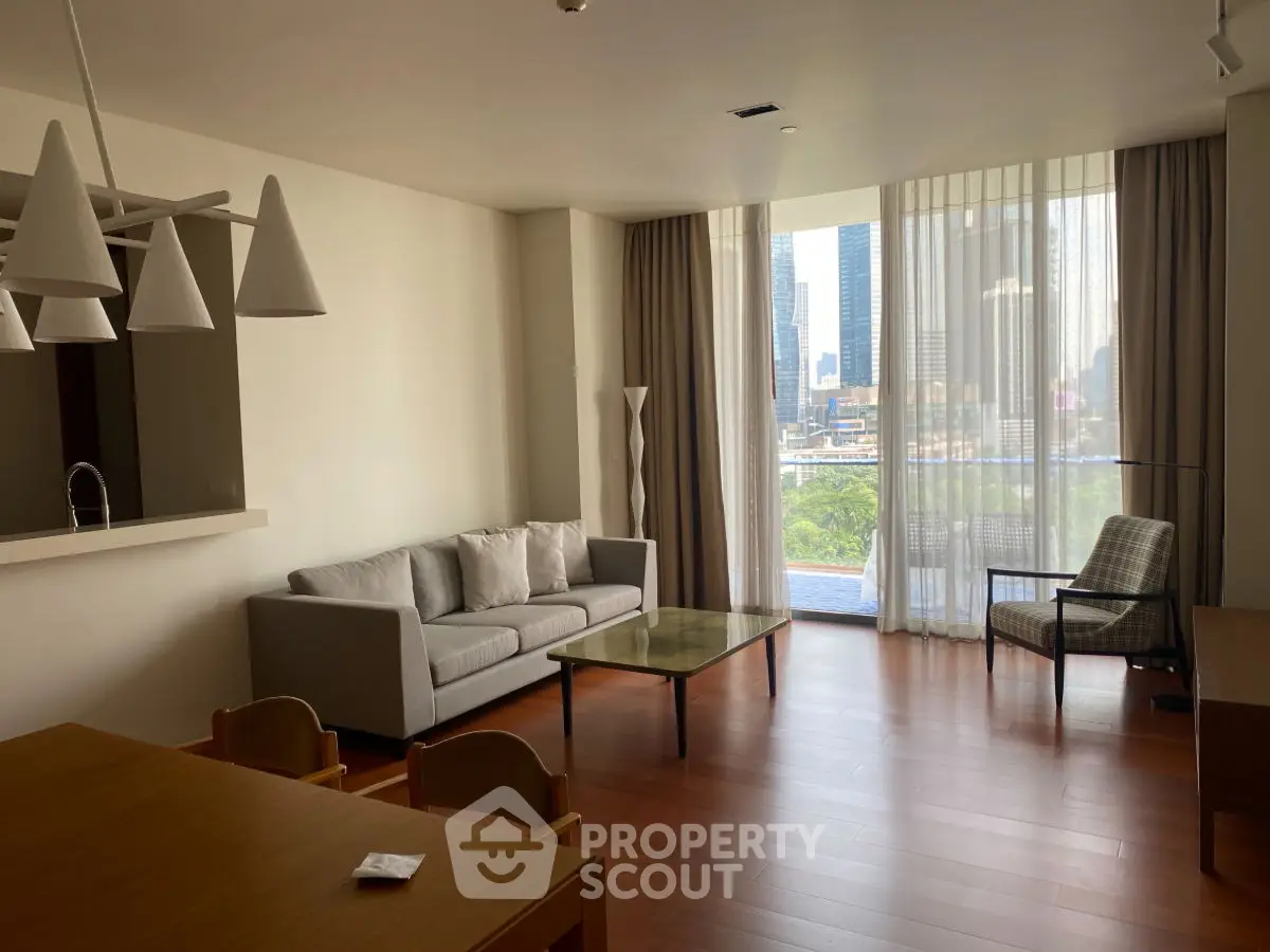 Spacious living room with modern furniture and city view