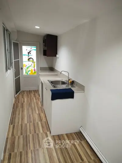 Compact kitchen with modern design and wooden flooring