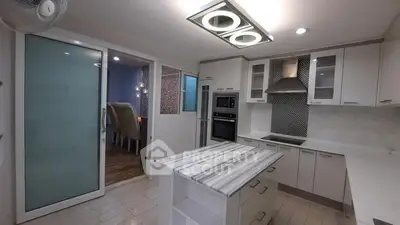 Modern kitchen with island and sleek appliances in a stylish home