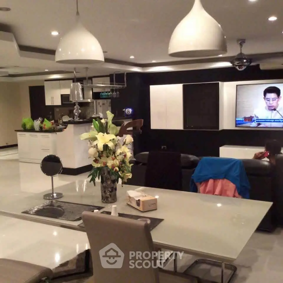Spacious modern living room with open kitchen layout and elegant dining area.