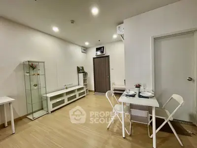 Modern living room with dining area and wooden flooring in a cozy apartment