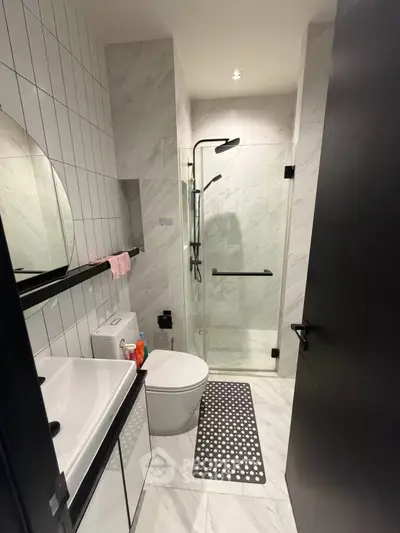 Modern bathroom with sleek shower and stylish fixtures in a contemporary apartment.