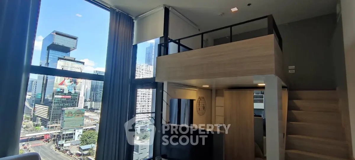 Modern loft apartment with large windows and city view, featuring a stylish mezzanine and sleek interior design.
