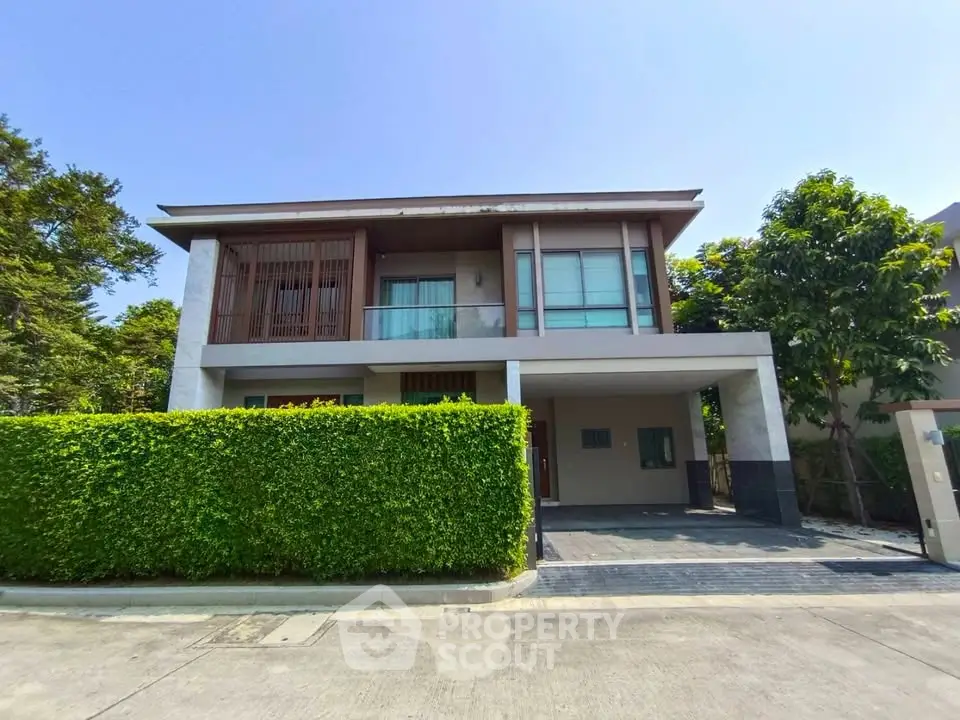 Modern two-story house with lush greenery and spacious driveway