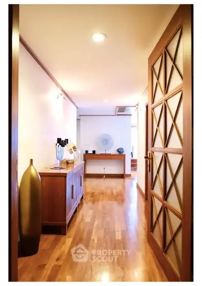 Elegant hallway with wooden flooring and stylish decor in modern home