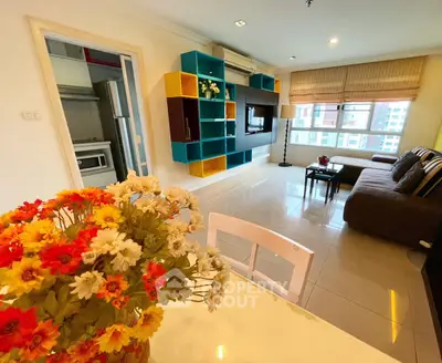 Modern living room with colorful shelving and cozy seating area, perfect for relaxation.