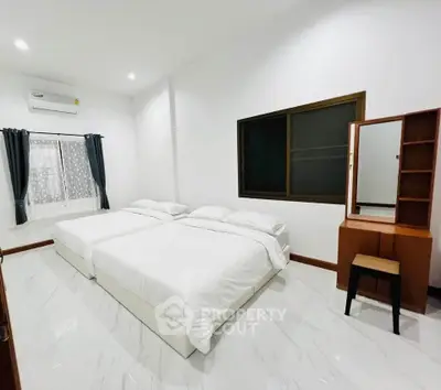 Spacious bedroom with two beds and modern decor