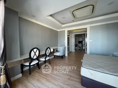 Spacious bedroom with elegant decor and modern furnishings in a luxury apartment.