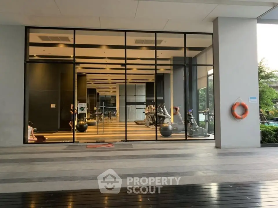 Modern gym with large glass windows in a luxury residential building