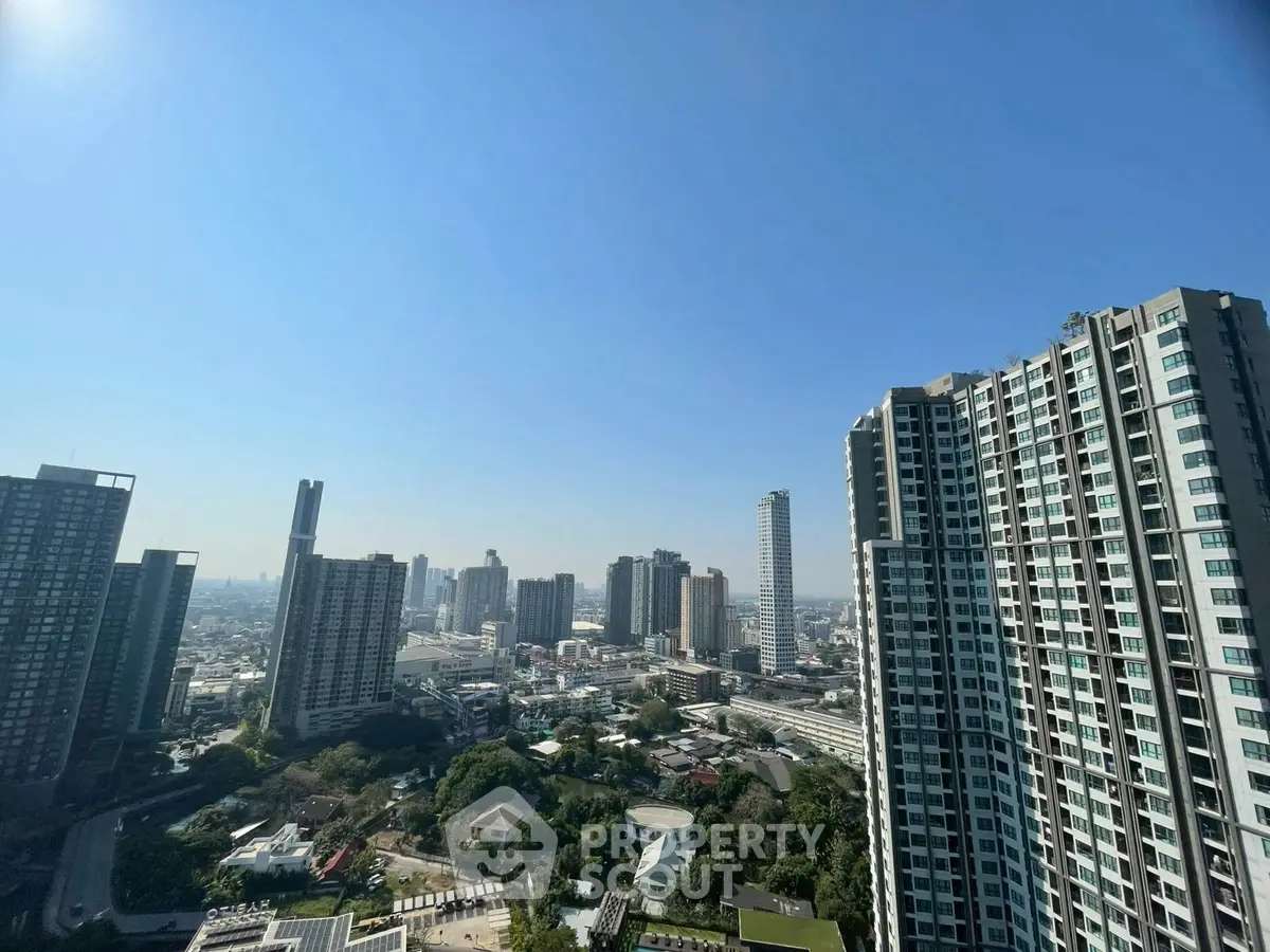 Stunning cityscape view from high-rise building balcony on a clear day.