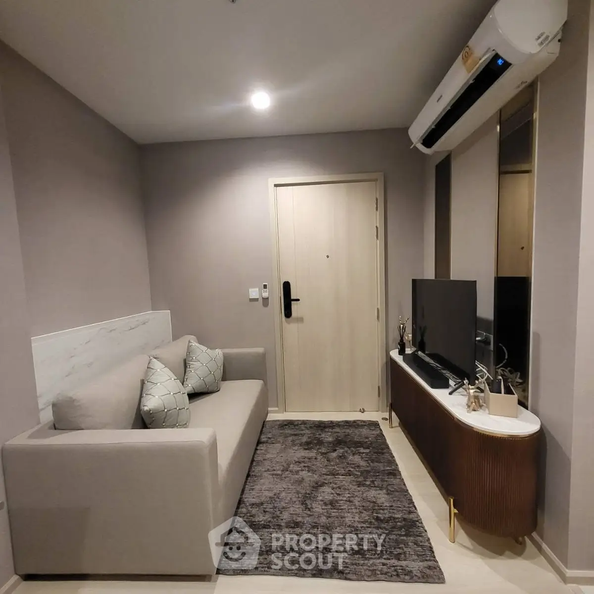 Modern living room with sleek furniture and air conditioning, perfect for cozy relaxation.