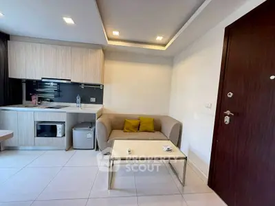 Modern compact living room with kitchenette in stylish apartment