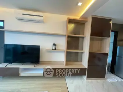 Modern living room with sleek built-in shelves and air conditioning unit