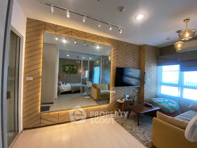 Modern living room with stylish decor, large mirror, and cozy seating area.