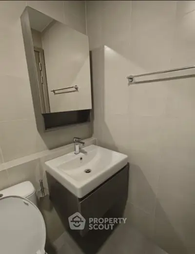Modern bathroom with sleek sink and mirror in minimalist design