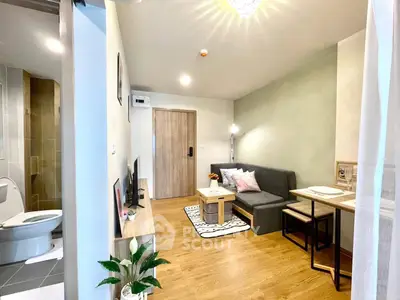 Modern living room with cozy seating and dining area, wooden flooring, and stylish decor.