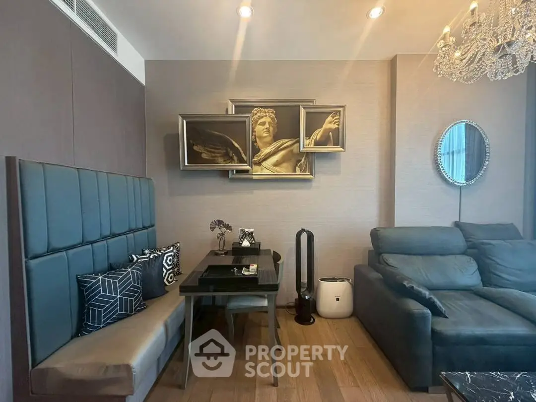 Luxurious living room with elegant decor and modern furniture, featuring a stylish chandelier and artistic wall art.