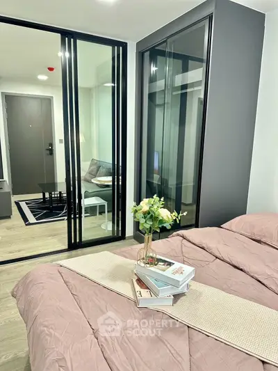 Modern bedroom with glass partition and cozy decor in stylish apartment