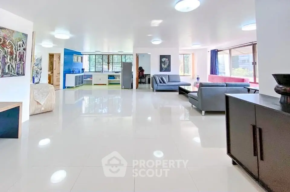 Spacious modern living room with open layout and stylish furniture in a bright apartment.
