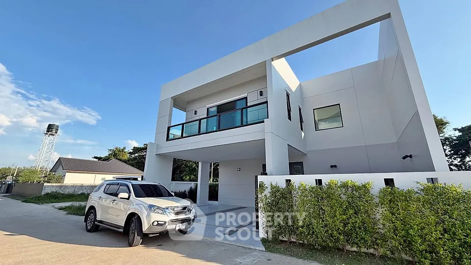 Modern two-story house with sleek design and spacious driveway in a serene neighborhood.