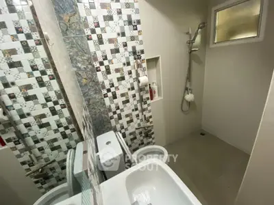 Modern bathroom with stylish tile design and shower area