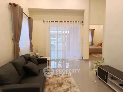 Spacious living room with modern decor and large windows for natural light.