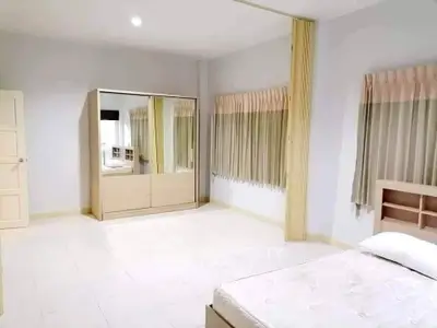 Spacious bedroom with modern wardrobe and large windows