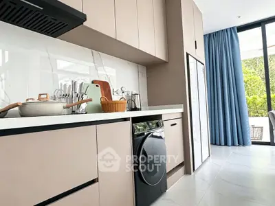 Modern kitchen with sleek cabinetry and built-in appliances, featuring a stylish open layout and natural light.